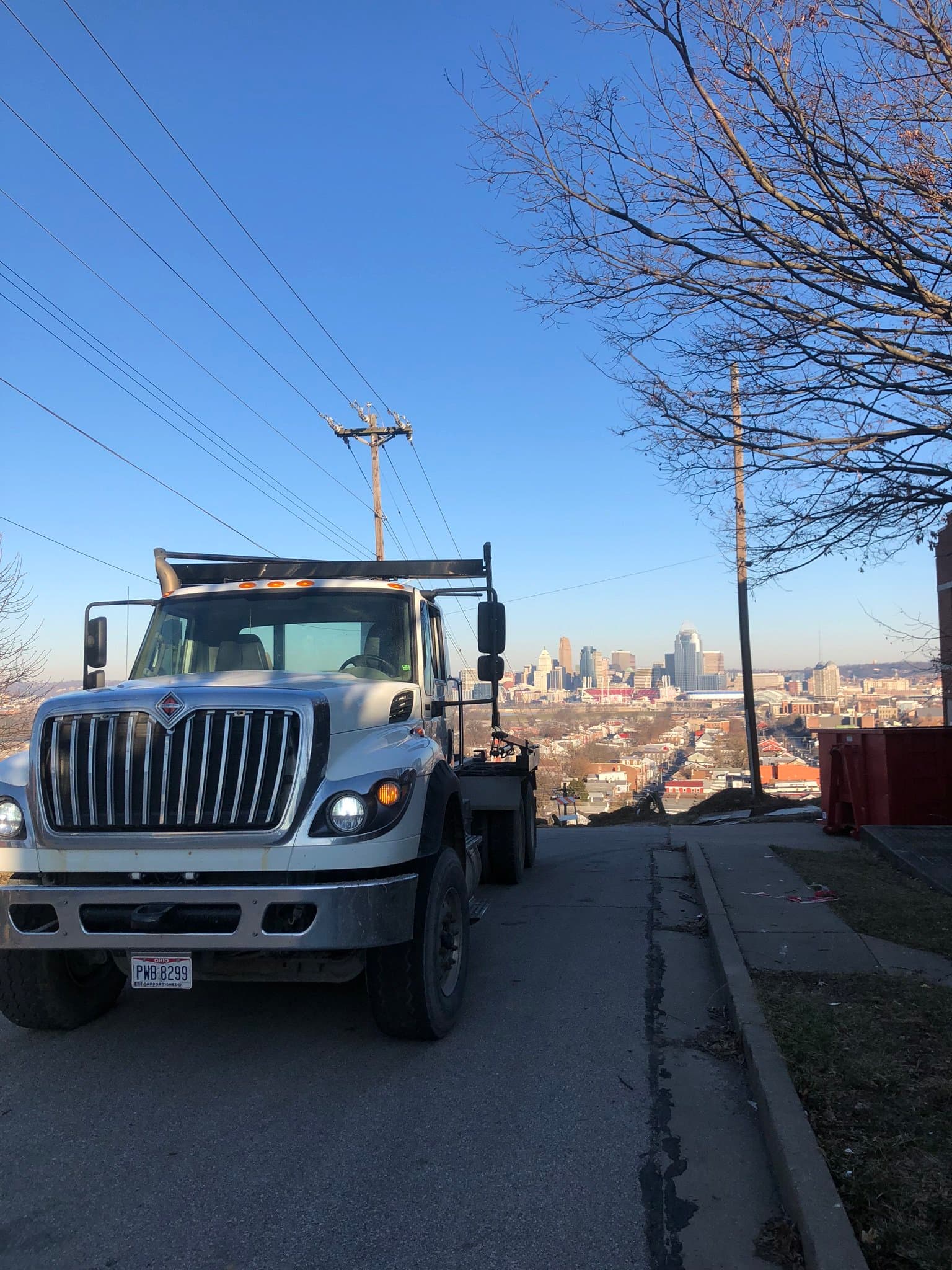 Klasmeier Containers roll-off truck overlooking the Cincinnati skyline